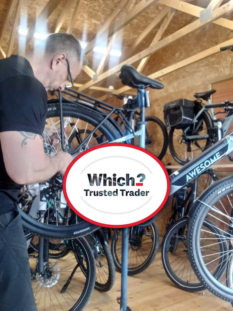 Background image of a workshop with tools and bikes