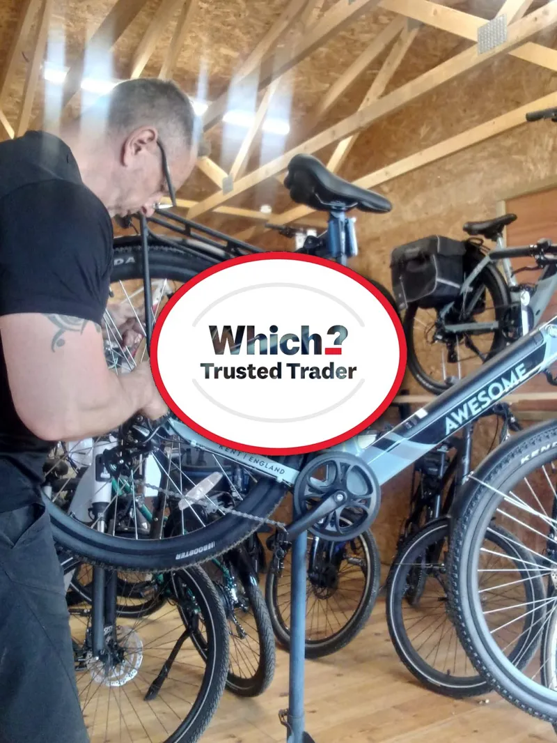 Background image of a workshop with tools and bikes